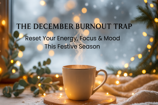 A cosy winter scene with a steaming mug, pine sprigs, golden fairy lights, and soft snowfall outside the window.