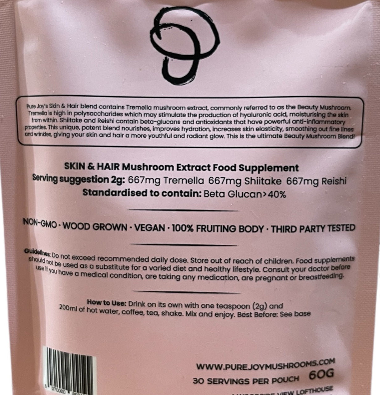 Pink package with black text of ingredients guidelines and a barcode on a white background