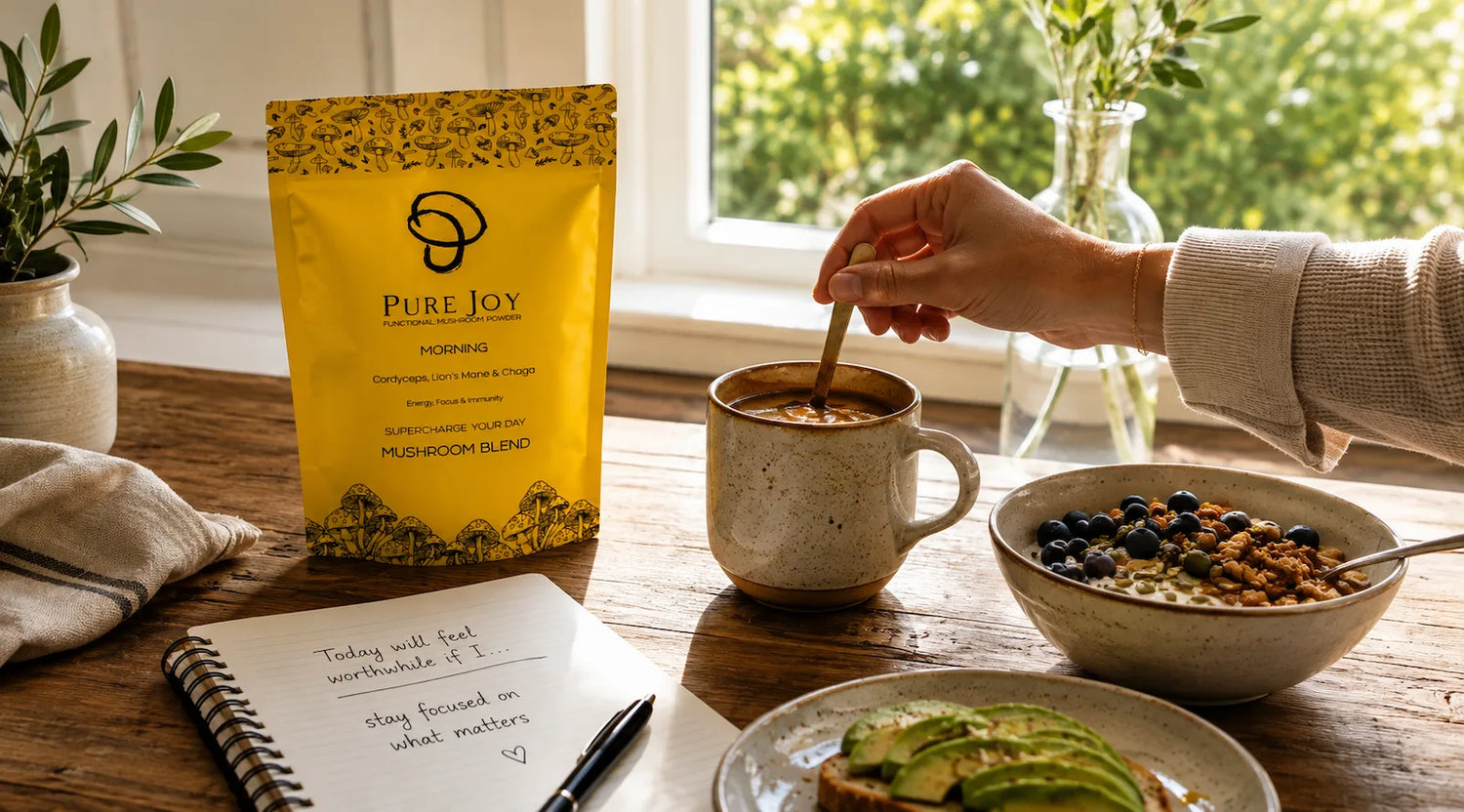 PURE JOY Morning Blend being stirred into coffee beside breakfast in a bright kitchen.